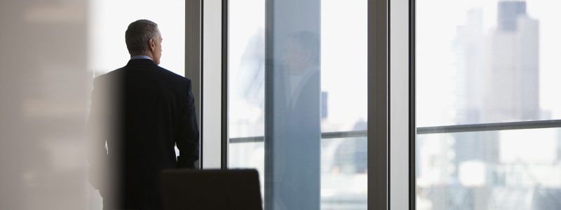 Businessman looking out conference room window